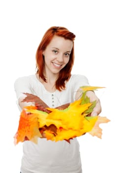 young beautiful red haired girl with leaves in her hands in front of white background