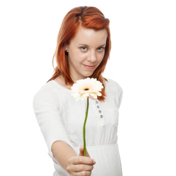 young beautiful red haired girl gives a flower to you in front of white background