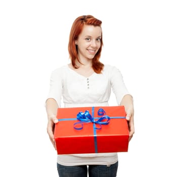 young beautiful red haired girl has a gift for you in front of white background