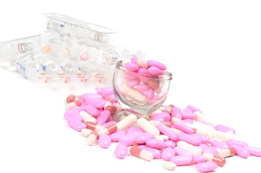 Shot of pink drugs (tablets) isolated on white