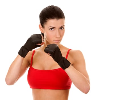 athletic brunette wearing boxing gloves on white isolated background