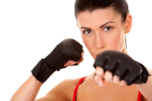 athletic brunette wearing boxing gloves on white isolated background