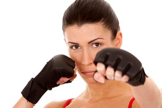 athletic brunette wearing boxing gloves on white isolated background