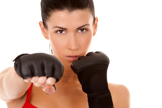 athletic brunette wearing boxing gloves on white isolated background