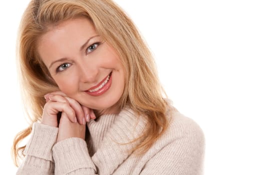 pretty blond woman wearing beige top sitting on white background