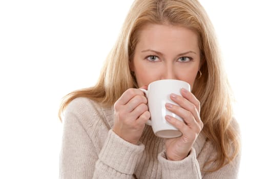 pretty blond woman wearing beige sweather drinking coffee