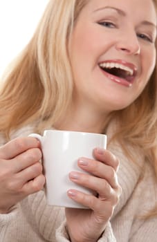 pretty blond woman wearing beige sweather drinking coffee