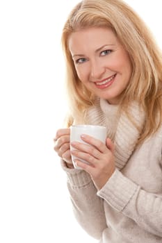 pretty blond woman wearing beige sweather drinking coffee