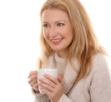pretty blond woman wearing beige sweather drinking coffee