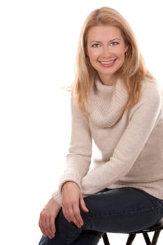 pretty blond woman wearing beige top sitting on white background