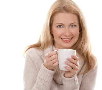 pretty blond woman wearing beige sweather drinking coffee