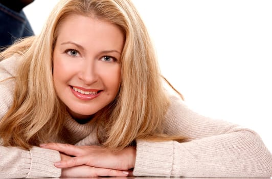 pretty blond woman wearing beige sweather on white background