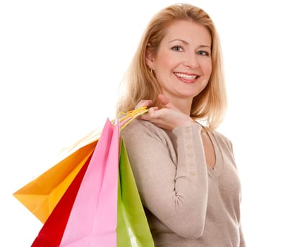 pretty blond woman wearing beige sweather holding shopping bags