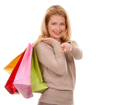 pretty blond woman wearing beige sweather holding shopping bags
