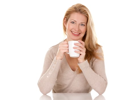 pretty blond woman wearing beige sweather drinking coffee