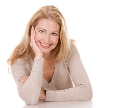 pretty blond woman wearing beige top sitting on white background