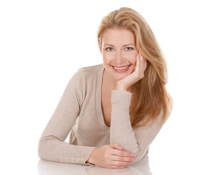 pretty blond woman wearing beige top sitting on white background