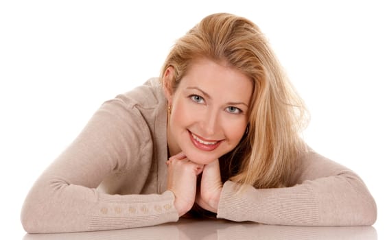 pretty blond woman wearing beige top sitting on white background
