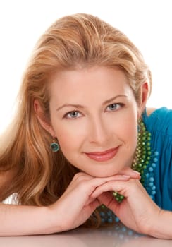 classy blond woman in her 40s wearing turquois dress