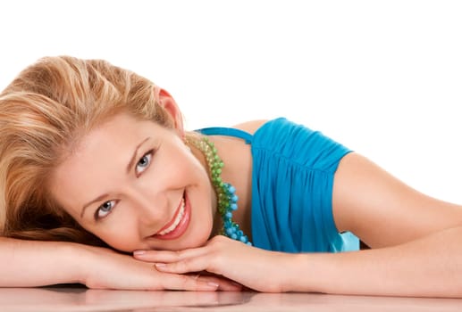 classy blond woman in her 40s wearing turquois dress