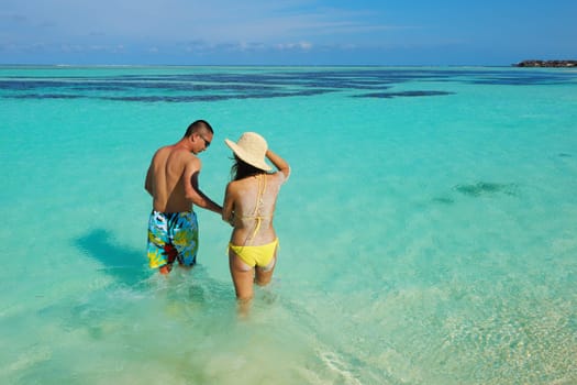 happy young asian couple enjoying summer and have on beautiful white sand beach