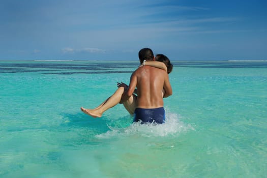 happy young asian couple enjoying summer and have on beautiful white sand beach