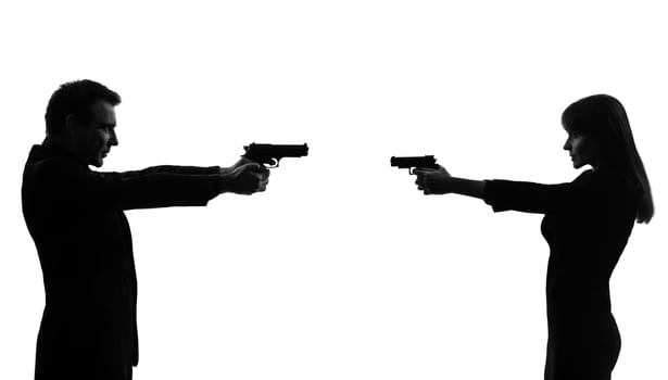 one caucasian couple woman man in duel   in silhouette studio isolated on white background