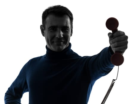 one caucasian man on the phone portrait in silhouette studio isolated on white background