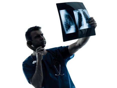 one caucasian man doctor surgeon radiologist medical examaning lung torso  x-ray image silhouette isolated on white background