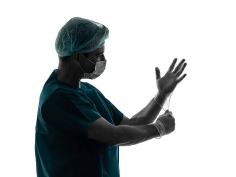 one caucasian doctor surgeon man  latex gloves portrait with face mask medical worker silhouette isolated on white background