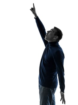 one caucasian man pointing up surprised  full length in silhouette studio isolated on white background