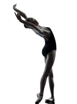 one caucasian young woman ballerina ballet dancer stretching warming up in silhouette studio on white background