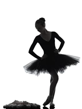one caucasian young woman ballerina ballet dancer dancing with tutu in silhouette studio on white background