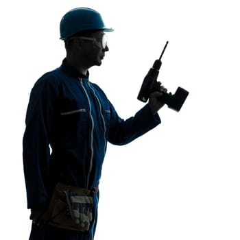 one caucasian man construction worker holding drill silhouette in studio on white background