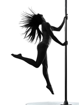 one caucasian woman pole dancer dancing in silhouette studio isolated on white background