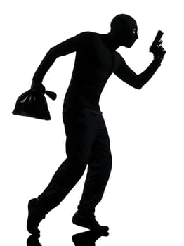 thief criminal holding gun in silhouette studio isolated on white background