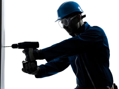 one caucasian man construction worker holding drill silhouette in studio on white background