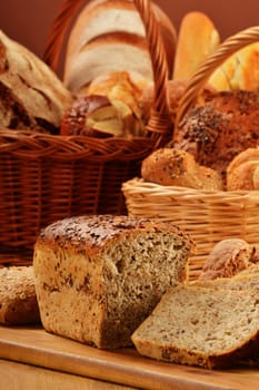 Composition with bread and rolls in wicker basket