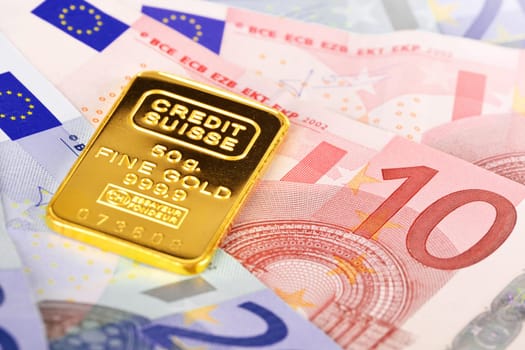 Composition with euro banknotes and swiss gold bar
