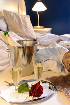 Champagne rose in bed celebrate special occasion hotel bedroom