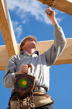 construction worker  at work with wooden  roof construction