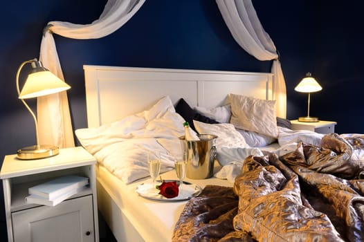 Rumpled sheets luxury hotel bedroom romantic night unmade bed