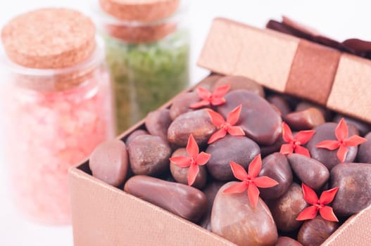 Spa concept - a gift of wellness with red zen stones and flowers