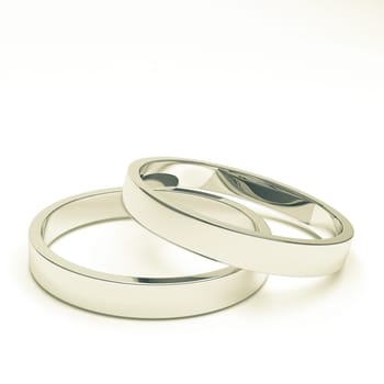 A pair of isolated silver or platinum weddings rings.