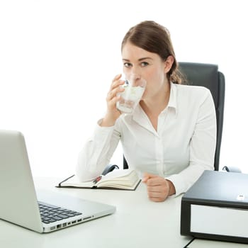 young brunette business woman is drinking water in front of desk