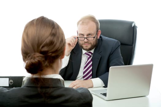 beard business man brunette woman at desk looking serious