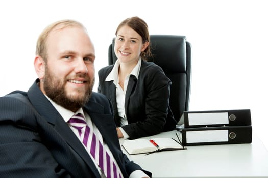 beard business man brunette woman at desk smiling