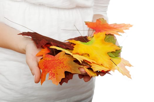 young beautiful girl with leaves in her hands in front of white background