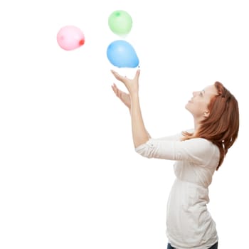 young beautiful red haired girl with ballons in front of white background