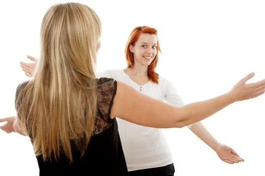 young beautiful red and blond haired girls in front of white background